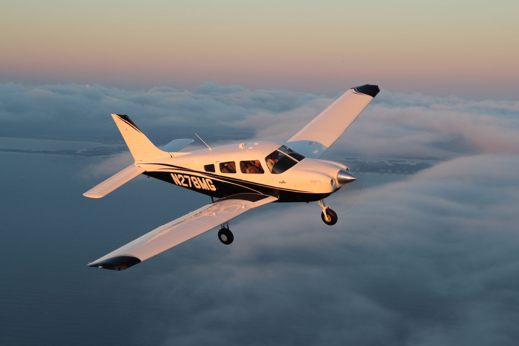 Piper Aircraft Archer TX Flying Above Clouds
