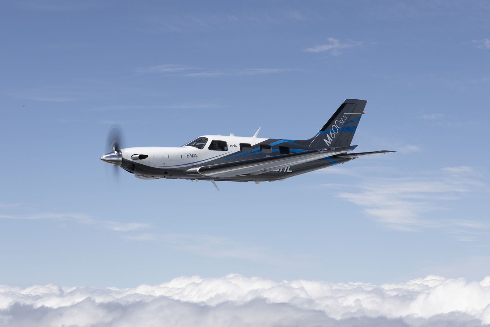 Piper M600/SLS aircraft flying over the clouds
