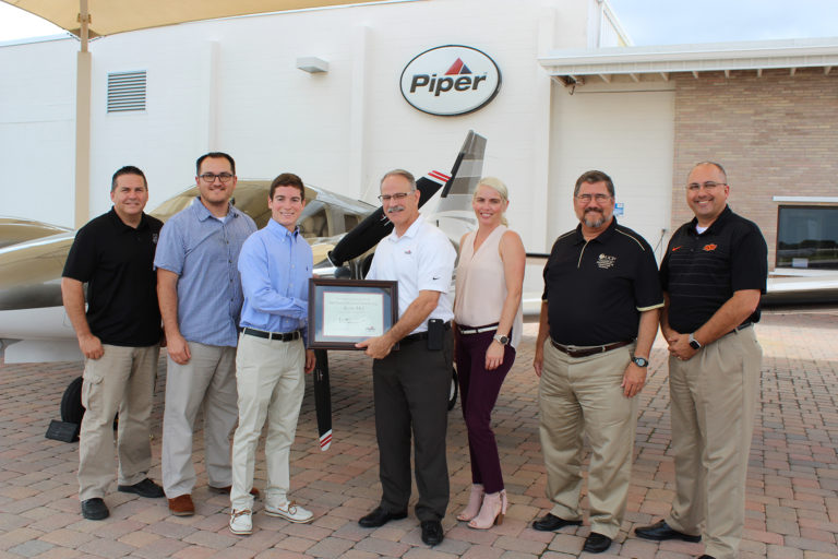 Piper scholarship recipient with some employees from Piper Aircraft