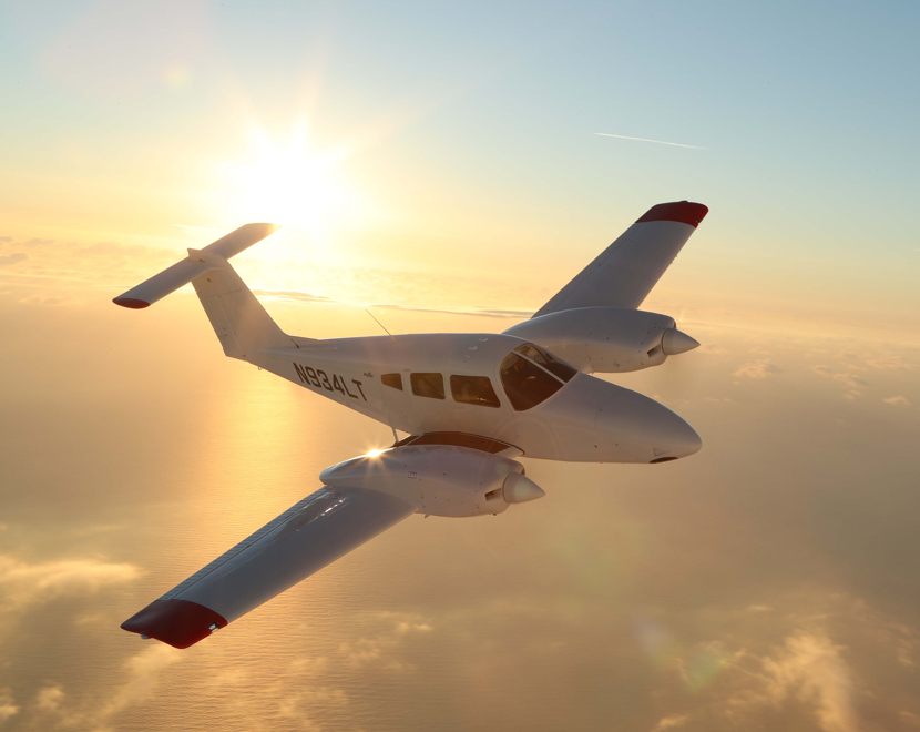 Piper Aircraft flying over the ocean