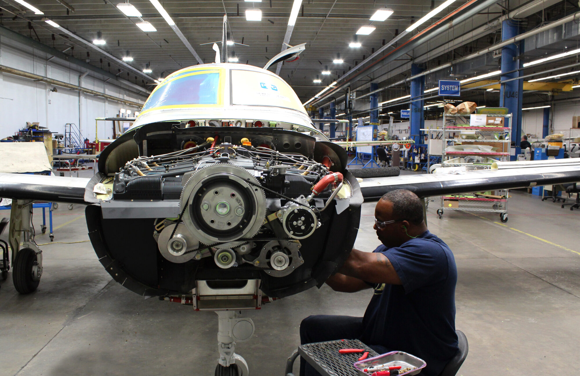 Employee working on the nose of an aircraft