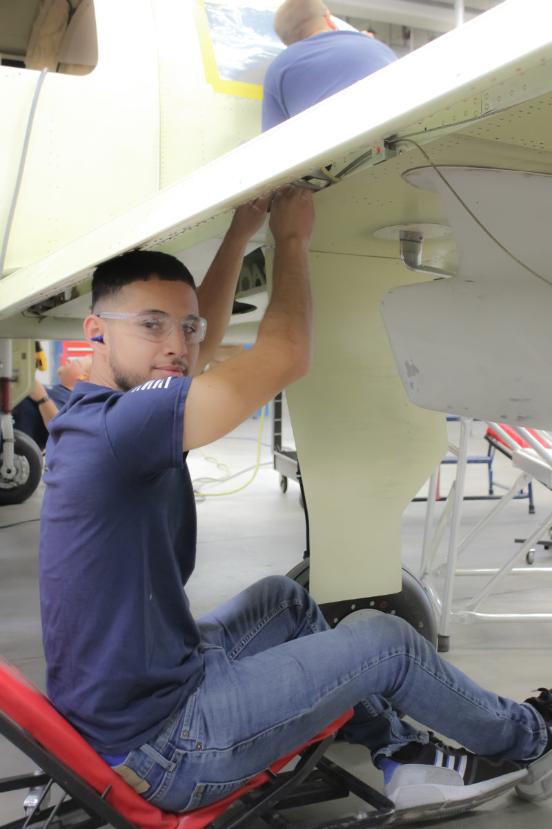 Employee working on the bottom on a wing