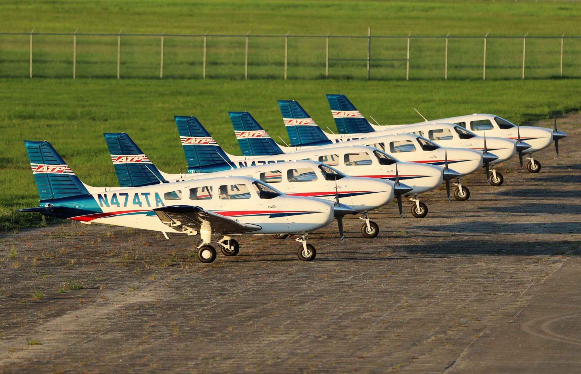 A fleet of Piper Trainer aircraft at a Piper Flight School Alliance member's campus