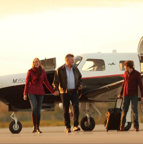 Family disembarking a Piper M350 aircraft