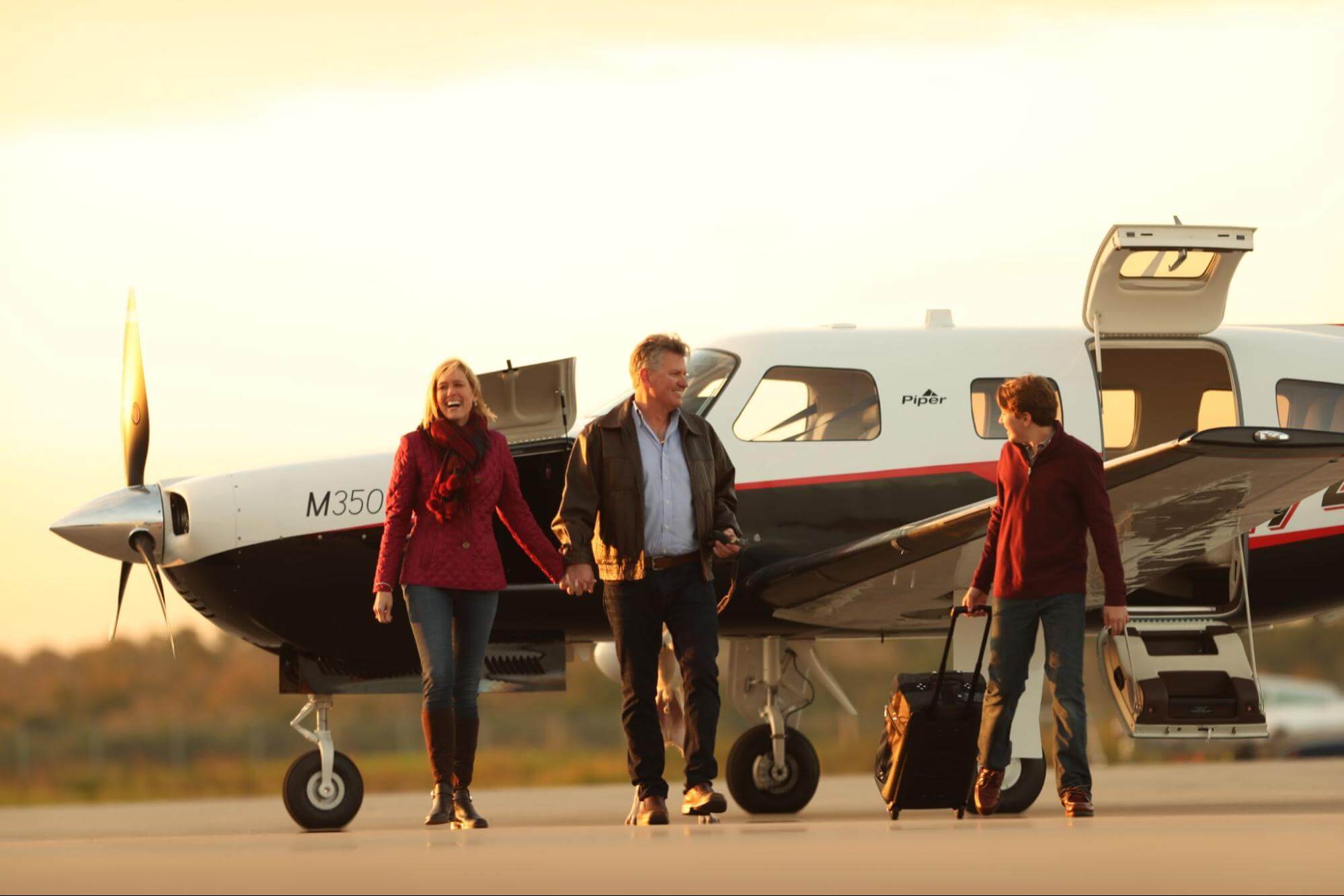 Family disembarking a Piper M350 aircraft