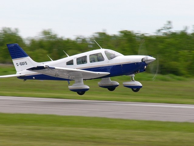 A Piper PA-28 Cherokee mid-takoff.