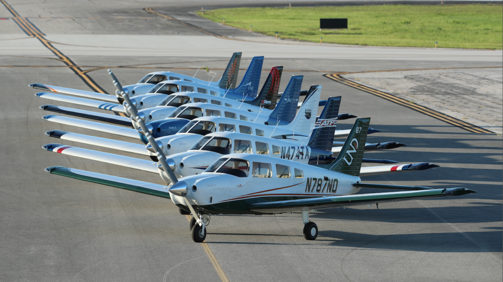 A fleet of Piper Archer trainers on the runway