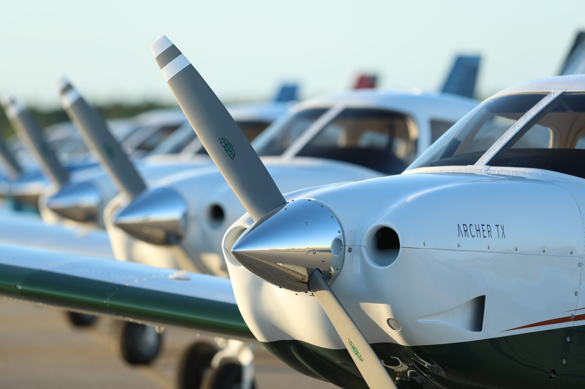 A fleet of Archer TX trainer aircraft at a flight school