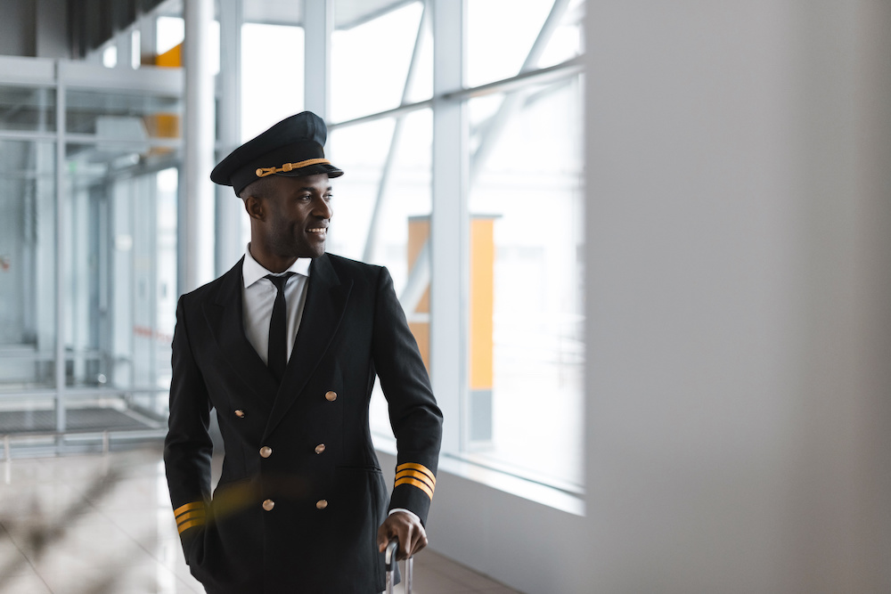 A commercial airline pilot walking through an airport