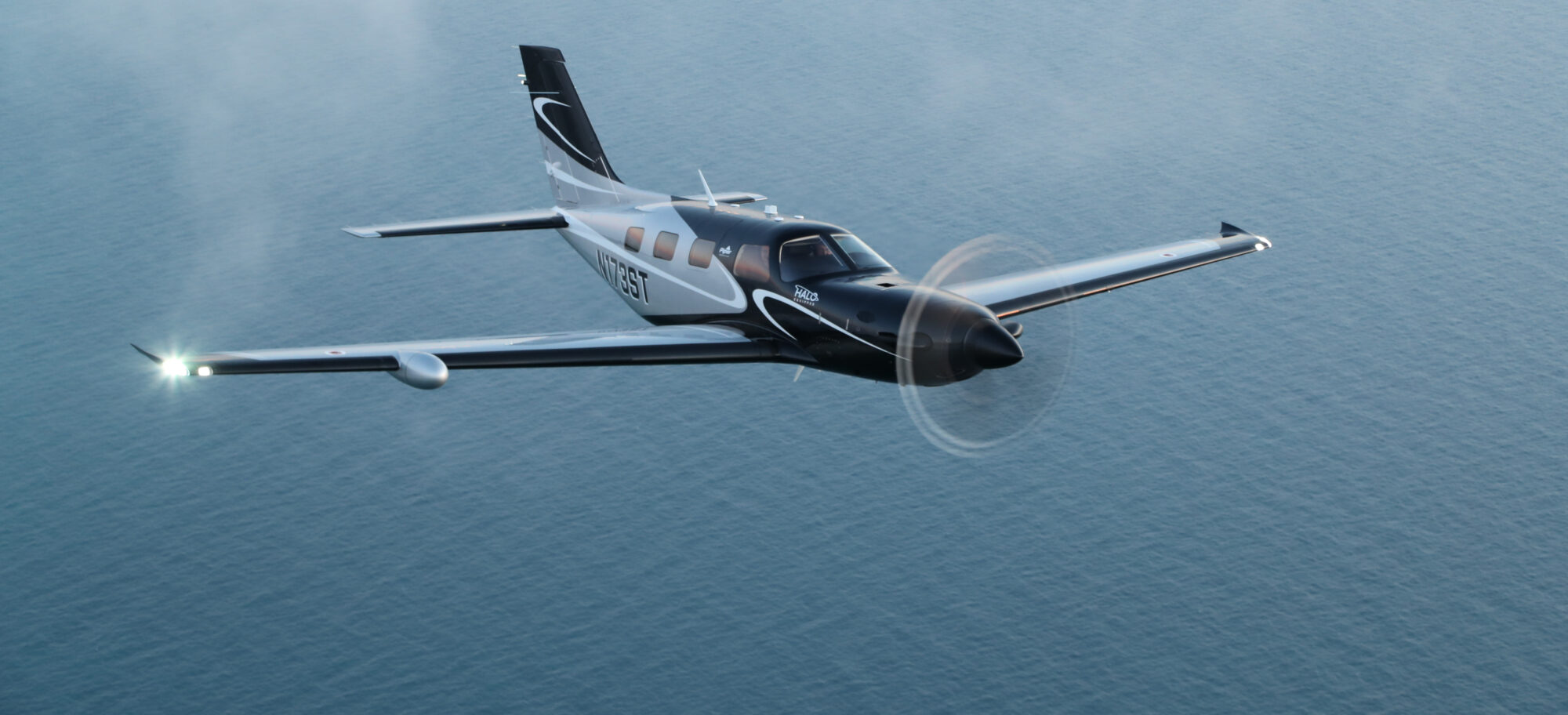 A Piper M600 aircraft flying above the water