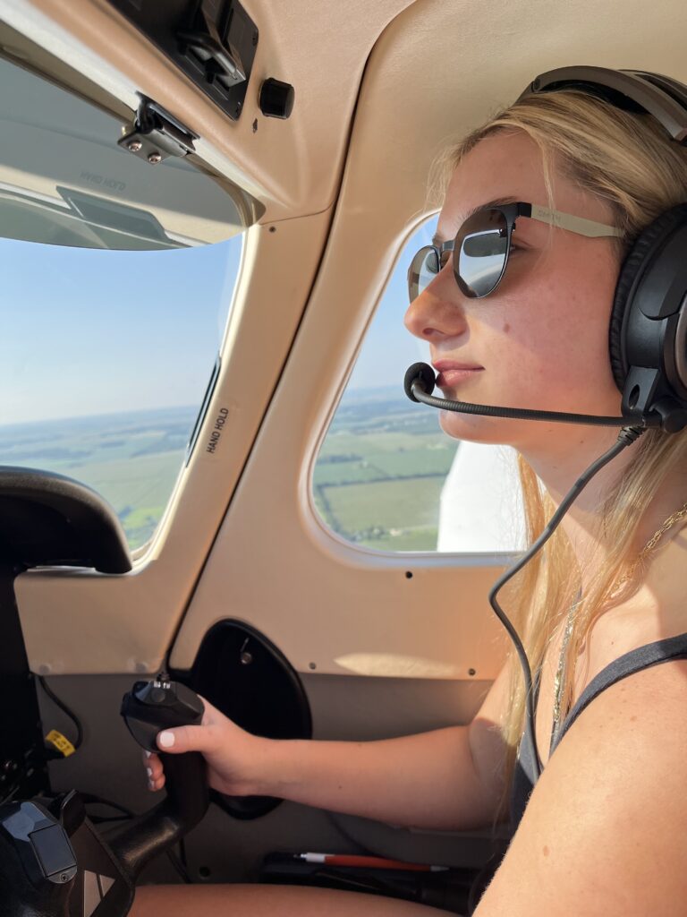A woman piloting a plane.