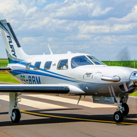 How To Progress From the Archer LX to the M700 Fury 7 Side view of a Piper M700 Fury taxiing on a runway with propeller spinning and green fields in the background.