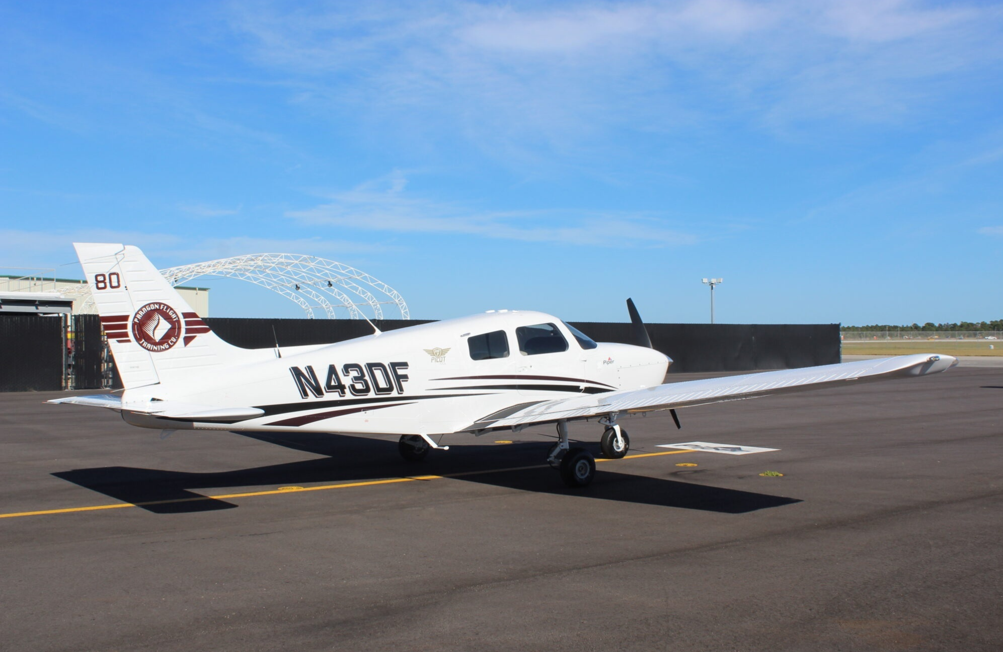 Paragon Flight Training Reaches Milestone with Announcement of All-Piper Aircraft Fleet 7 White N43DF plane parked on runway with blue sky in background
